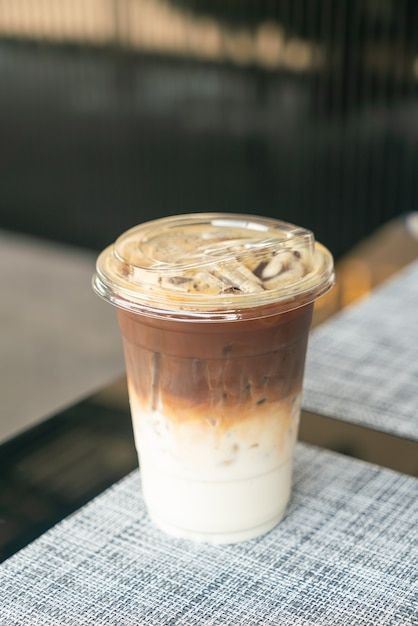 Iced latte coffee cup on table in cafe coffee shop _ Premium Photo